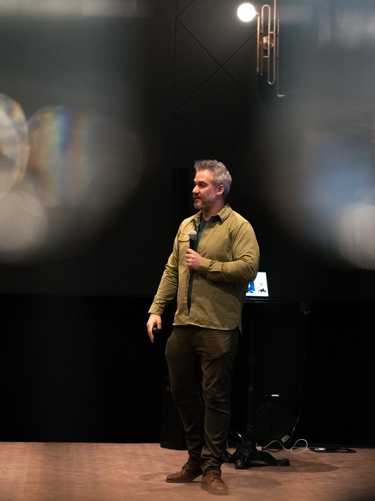 Greg Buda presenting a masterclass on stage in Warsaw